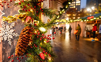 Holiday decorations at the Herald Square Christmas Market on a winter night in New York City.